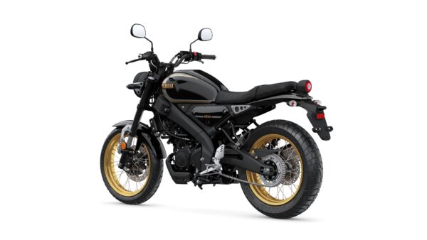 A black Yamaha motorcycle with gold rims, viewed from a slight rear angle, showcasing its sleek design and modern features.