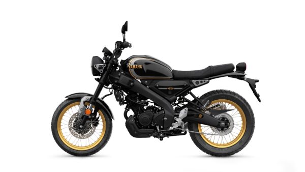 A Yamaha motorcycle with a sleek black design and gold accents, featuring a minimalist frame, large tires, and a comfortable seat, viewed from the side.