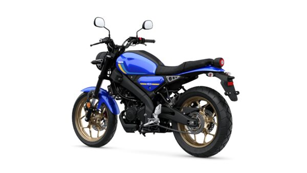 A blue Yamaha motorcycle viewed from the rear-left side, showcasing its sleek design, gold-accented wheels, and black seat.