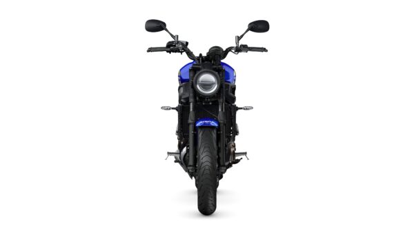 A front view of a blue motorcycle with a round headlight, black handlebars, and a wide tire on a white background.