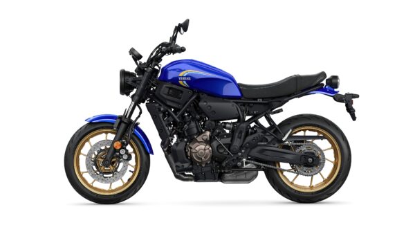 A side view of a blue Yamaha motorcycle with a sleek design, featuring gold alloy wheels and a black seat.