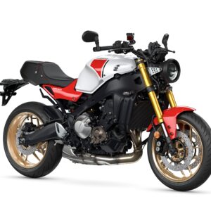 Yamaha 2024 XSR 900 A stylish motorcycle featuring a black and silver frame with red accents, a round headlight, and gold wheels, positioned on a white background.
