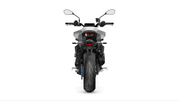 A rear view of a modern motorcycle, showcasing its wide tire, sleek body design, and handlebar controls against a plain white background.