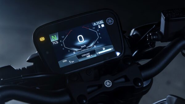 Close-up of a motorcycle dashboard displaying speedometer, odometer showing 1 km, coolant temperature at 48°C, and indicators for neutral and traction control, with a dark background.