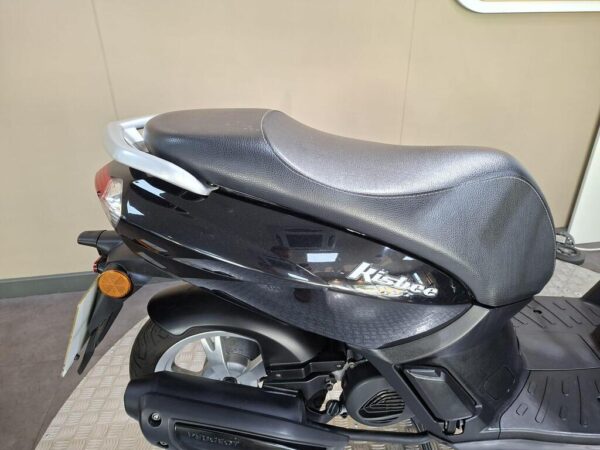 A close-up view of a black Peugeot Kisbee scooter, focusing on the seat and rear section, with an emphasis on its sleek design and details.