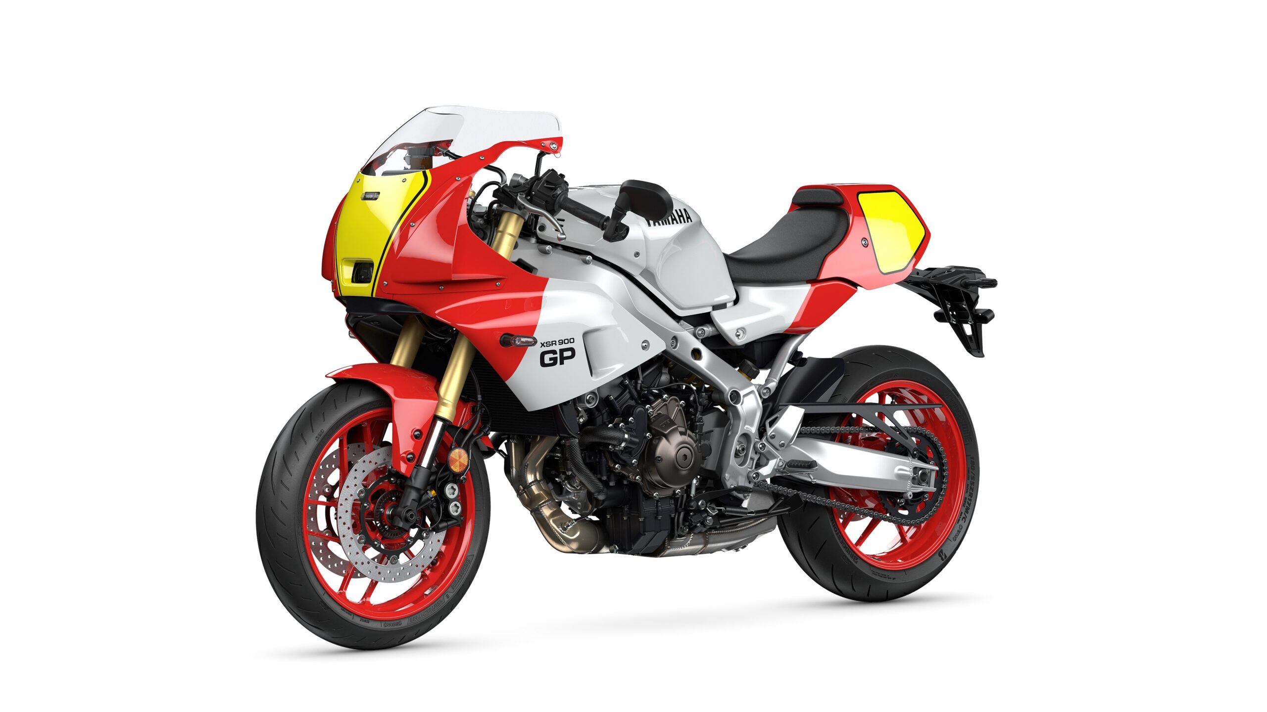 Yamaha 2026 XSR900 GP Legend Red - Lateral Left A red and silver Yamaha XSR900 GP motorcycle with sporty fairings and distinctive yellow accents, showcasing a sleek design and modern features.