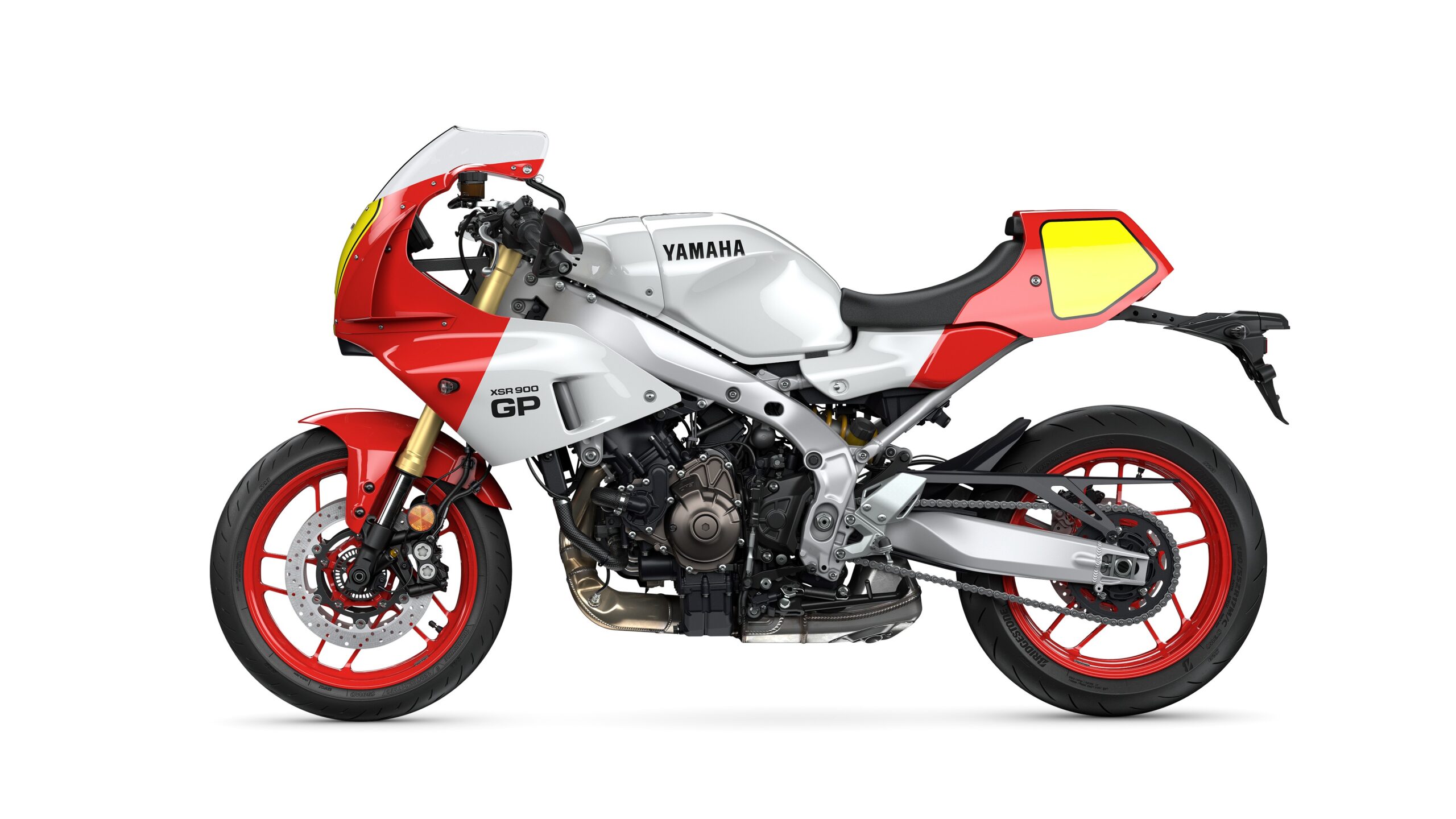 Yamaha 2026 XSR900 GP Legend Red - Left A side view of a Yamaha XSR 900 GP motorcycle featuring a modern design with a white and red color scheme, sport fairing, and distinctive red wheels.