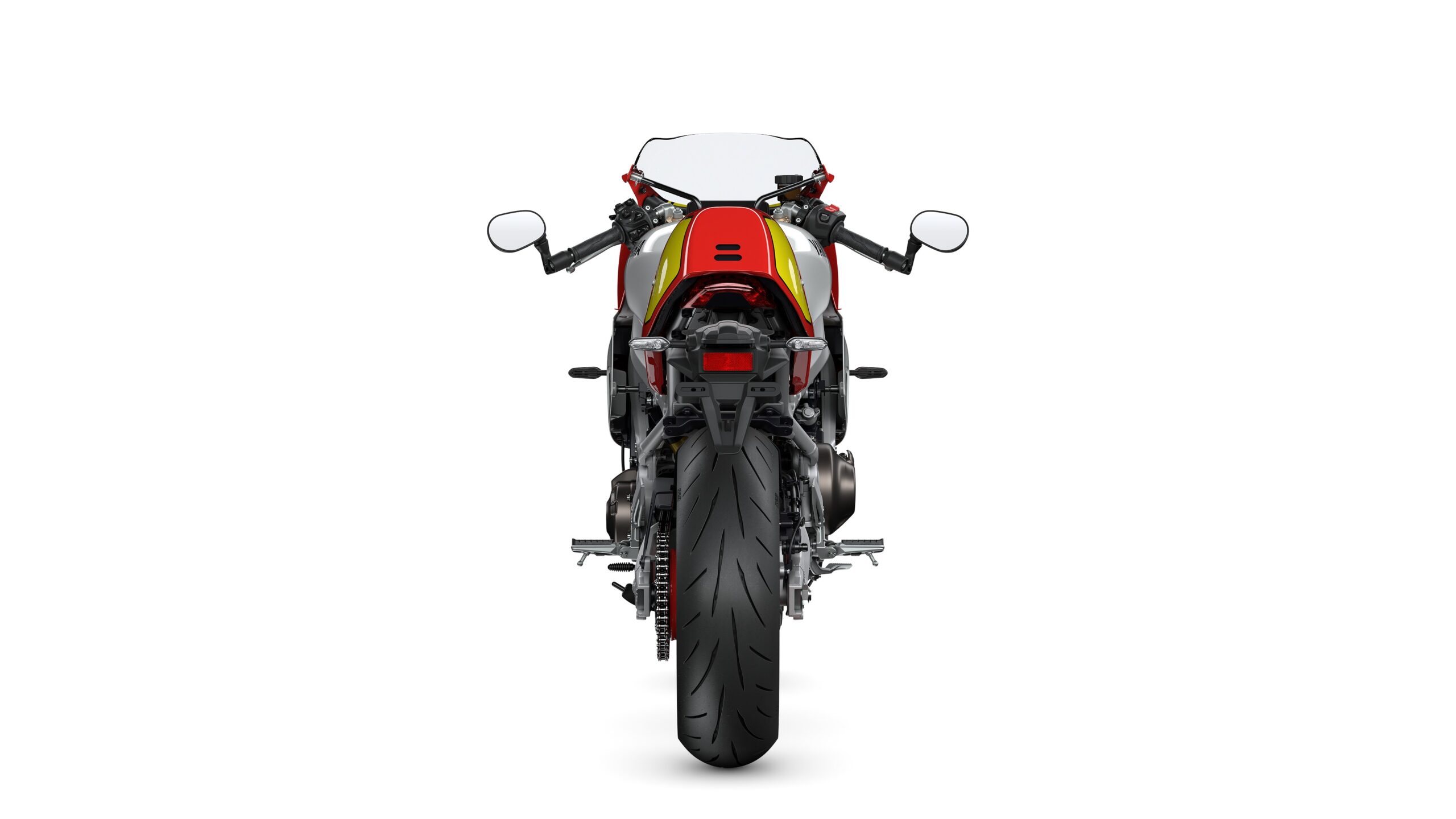 Yamaha 2026 XSR900 GP Legend Red - Rear A rear view of a motorcycle featuring a colorful design, prominent exhaust, and a wide rear tire on a white background.