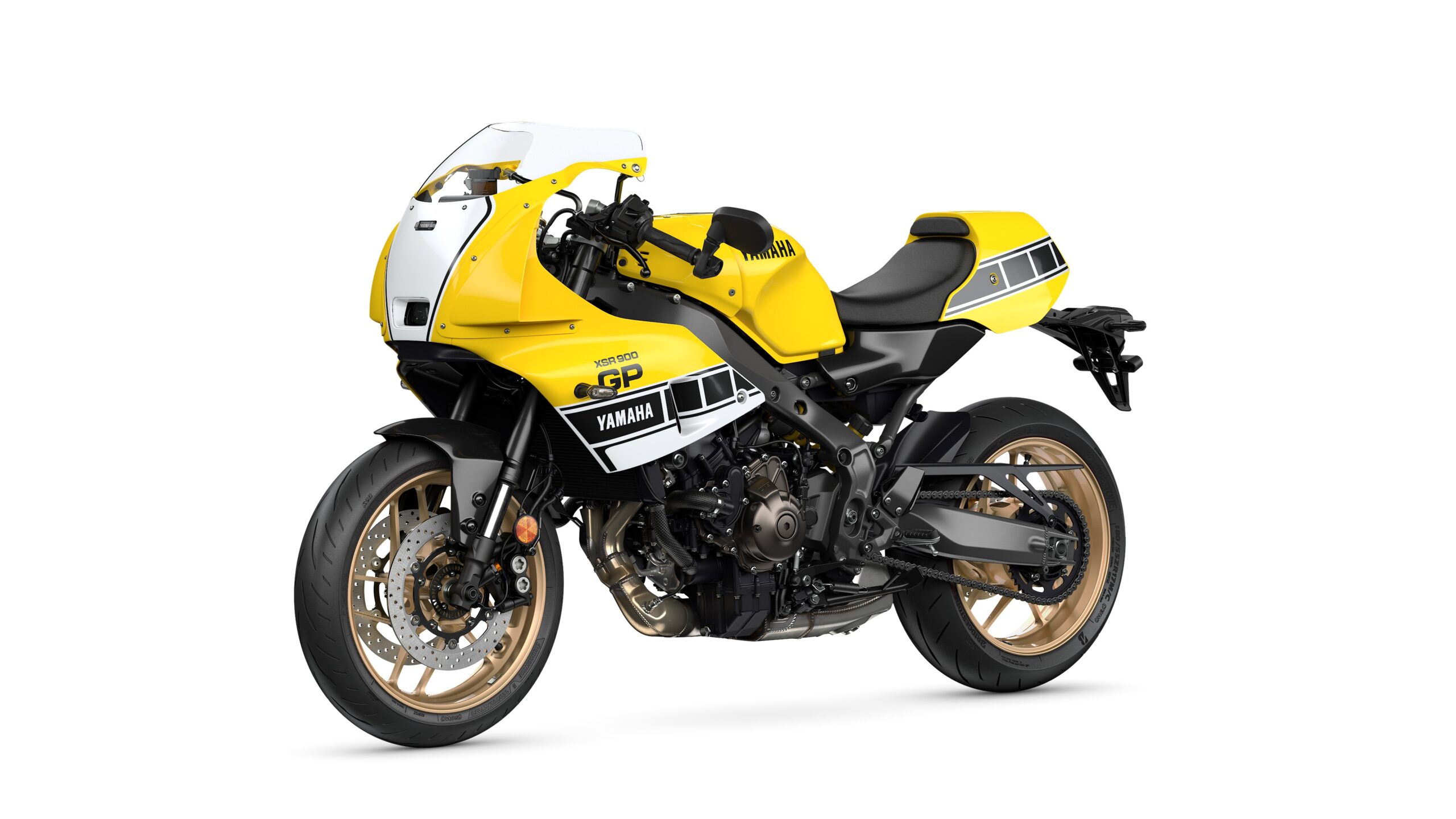 Yamaha 2026 XSR900 GP Legend Yellow - Lateral Left A vibrant yellow and black Yamaha motorcycle with a sporty design, featuring a prominent front fairing, sleek bodywork, and distinctive gold wheels.