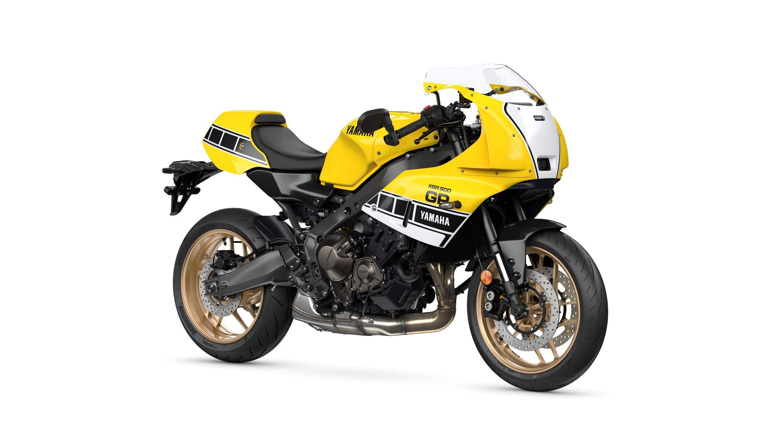Yamaha 2026 XSR900 GP Legend Yellow - Lateral Right Yamaha 2026 XSR900 GP A yellow Yamaha motorcycle with a sporty design, featuring black and white accents, gold wheels, and a distinctive front fairing.
