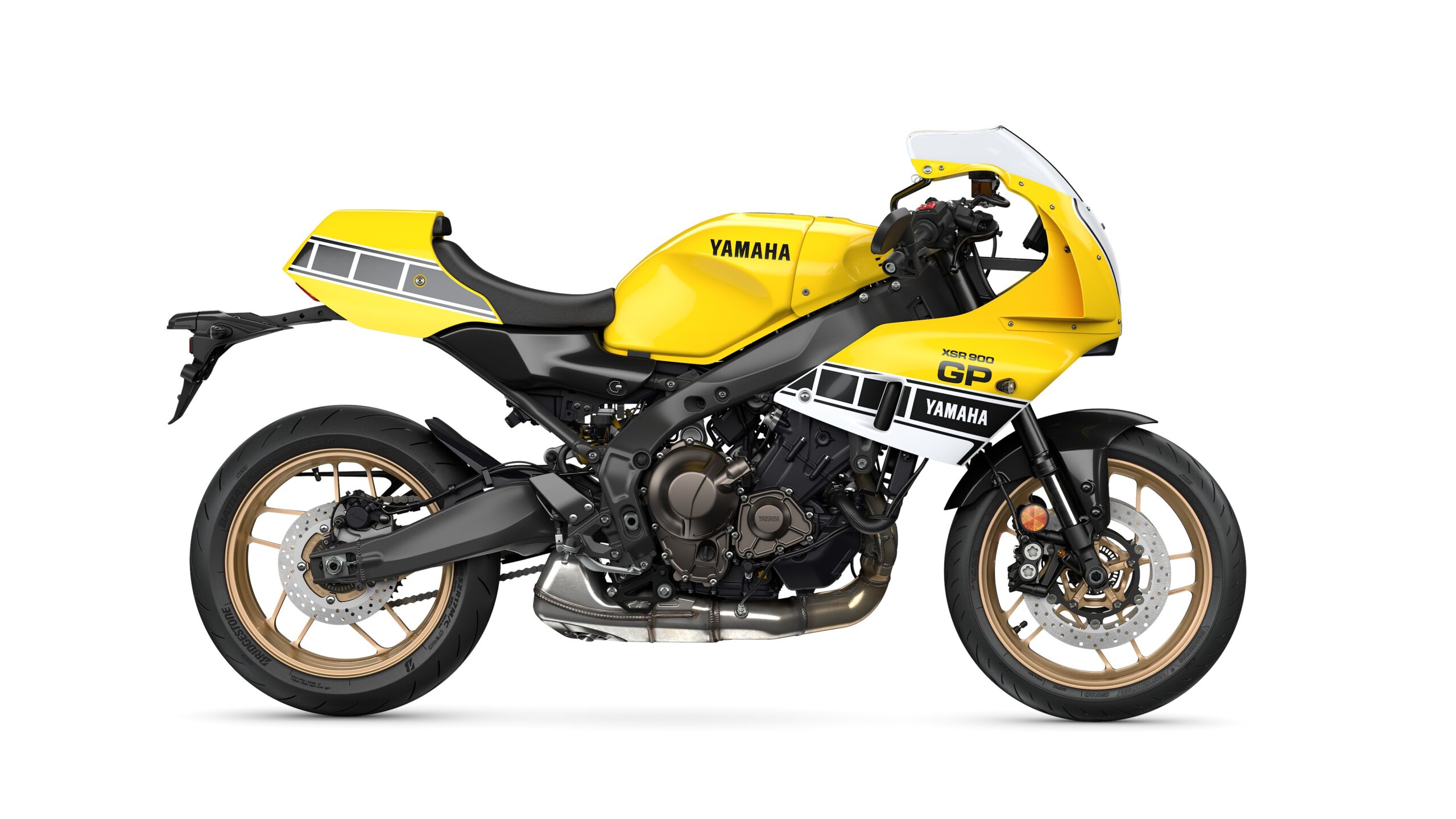 Yamaha 2026 XSR900 GP Legend Yellow - Right A vibrant yellow Yamaha motorcycle with sleek lines, featuring a black chassis, gold wheels, and a sporty fairing design.