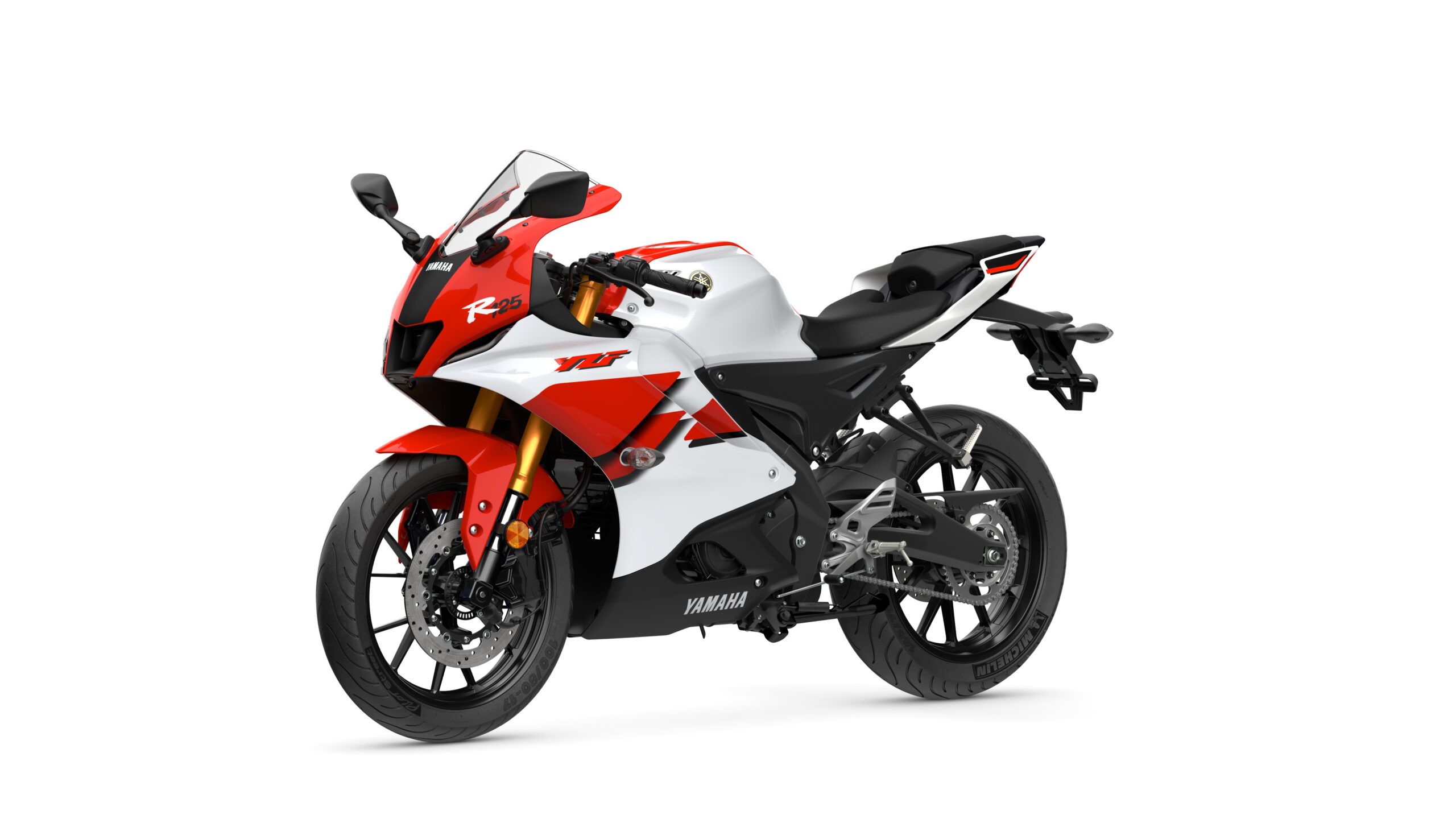 2026 Yamaha R125 Anniversary White Lateral Left A Yamaha R25 sports motorcycle featuring a striking red and white color scheme, with a sleek aerodynamic design, high-performance components, and modern styling elements.