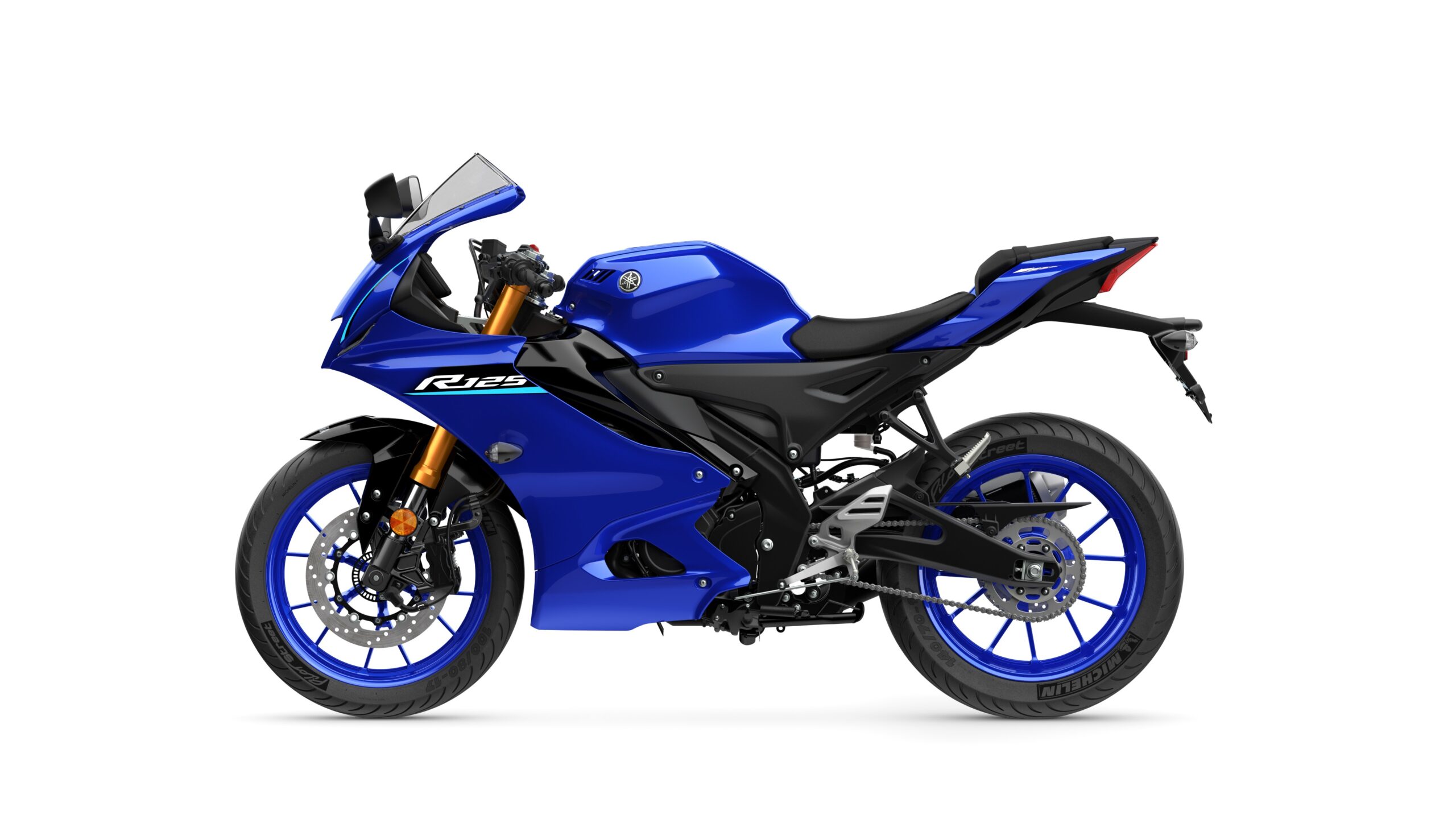 2026 Yamaha R125 Icon Blue Left A sleek blue Yamaha R125 motorcycle, showcasing a modern design with a fairing, sporty seat, and dual-tone wheels, is displayed against a white background.