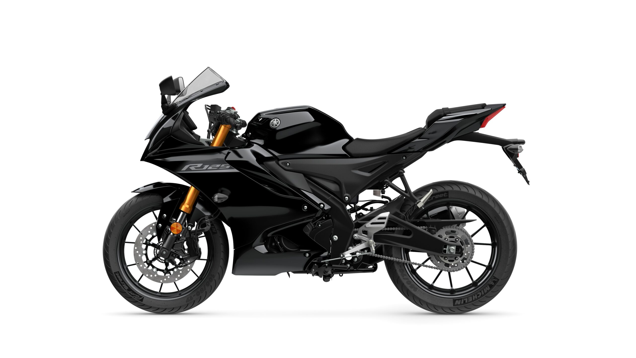 2026 Yamaha R125 Tech Black Left A sleek black sports motorcycle featuring a modern design, prominent fairings, and a distinctive front headlamp, positioned on a white background.