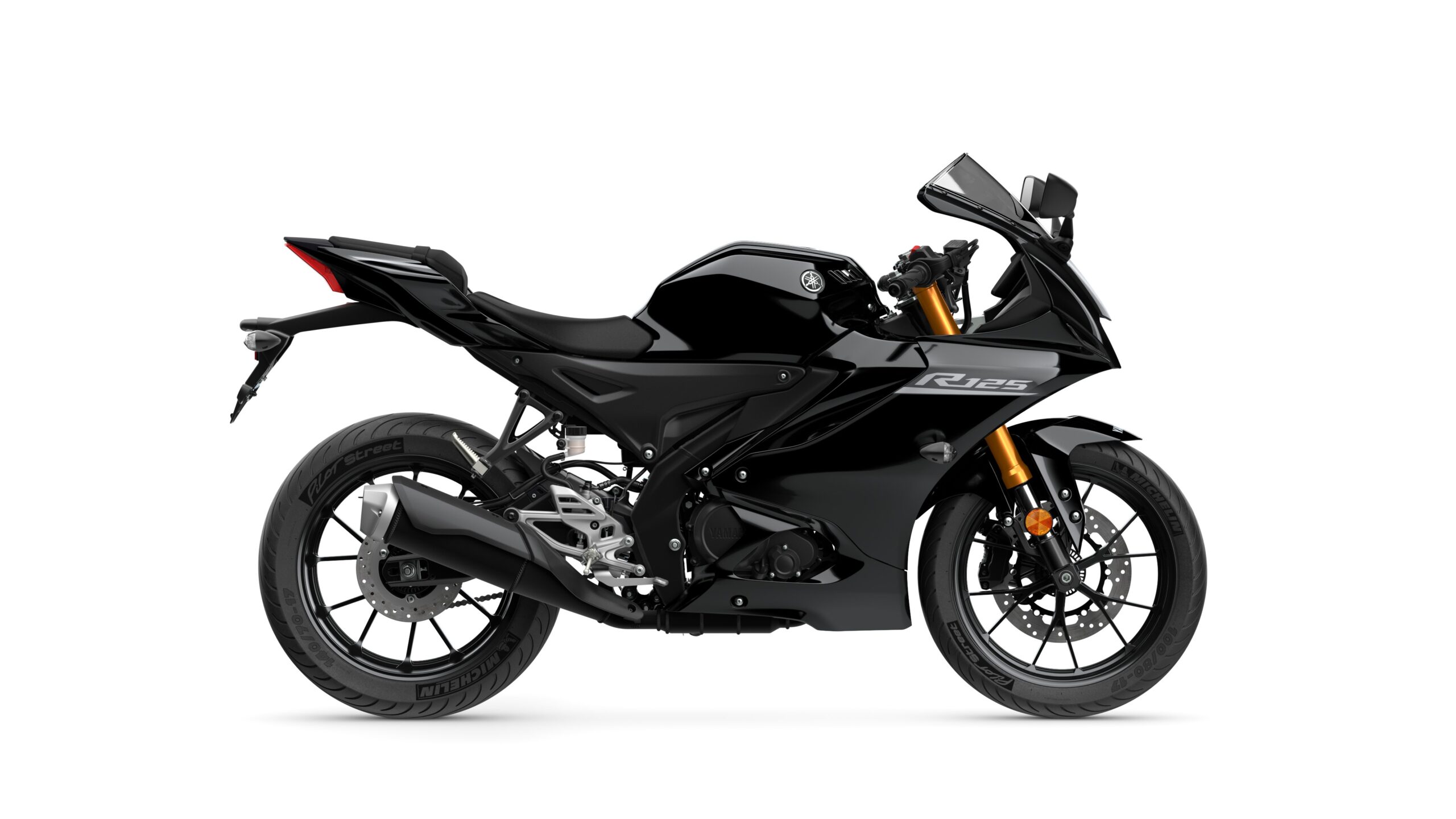 2026 Yamaha R125 Tech Black Right A sleek black sport motorcycle with a streamlined design, featuring a prominent "R125" logo, a raised tail section, and sporty wheels.