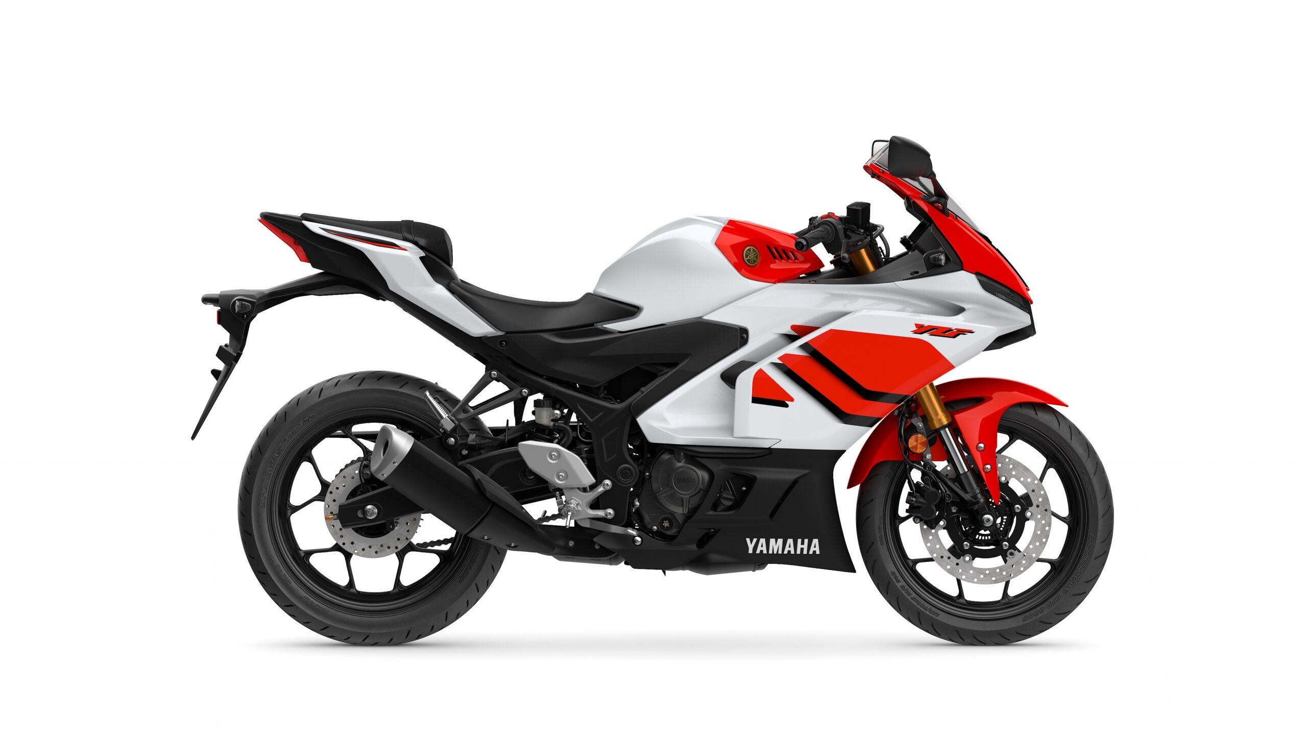 2026 Yamaha R3 Anniversary Edition Right A sleek, modern Yamaha motorcycle in white and red with black accents, displayed from the side on a white background.