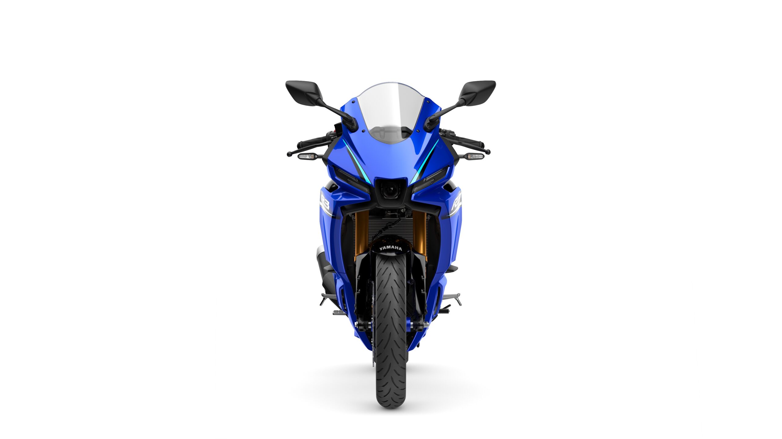 2026 Yamaha R3 Icon Blue Front A blue motorcycle viewed head-on, showcasing its sleek design, prominent headlights, and a distinctive front fairing. The vehicle features black mirrors and a textured tire in the foreground.