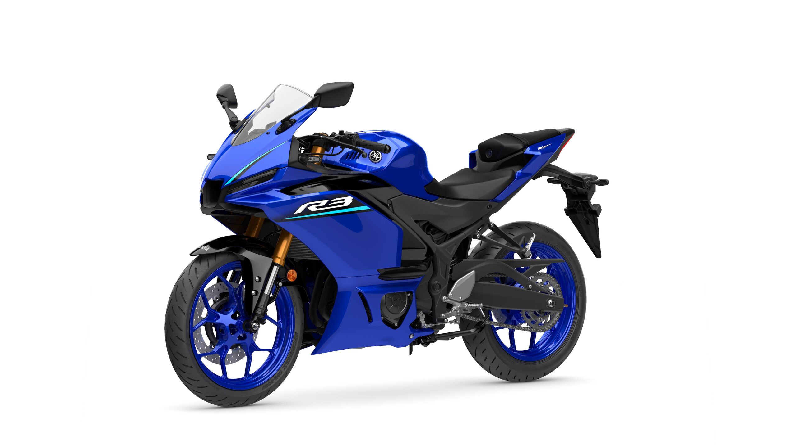 2026 Yamaha R3 Icon Blue Lateral Left A blue Yamaha R3 motorcycle with a sleek design, featuring a fairing, coated wheels, and a modern seating arrangement, positioned against a white background.