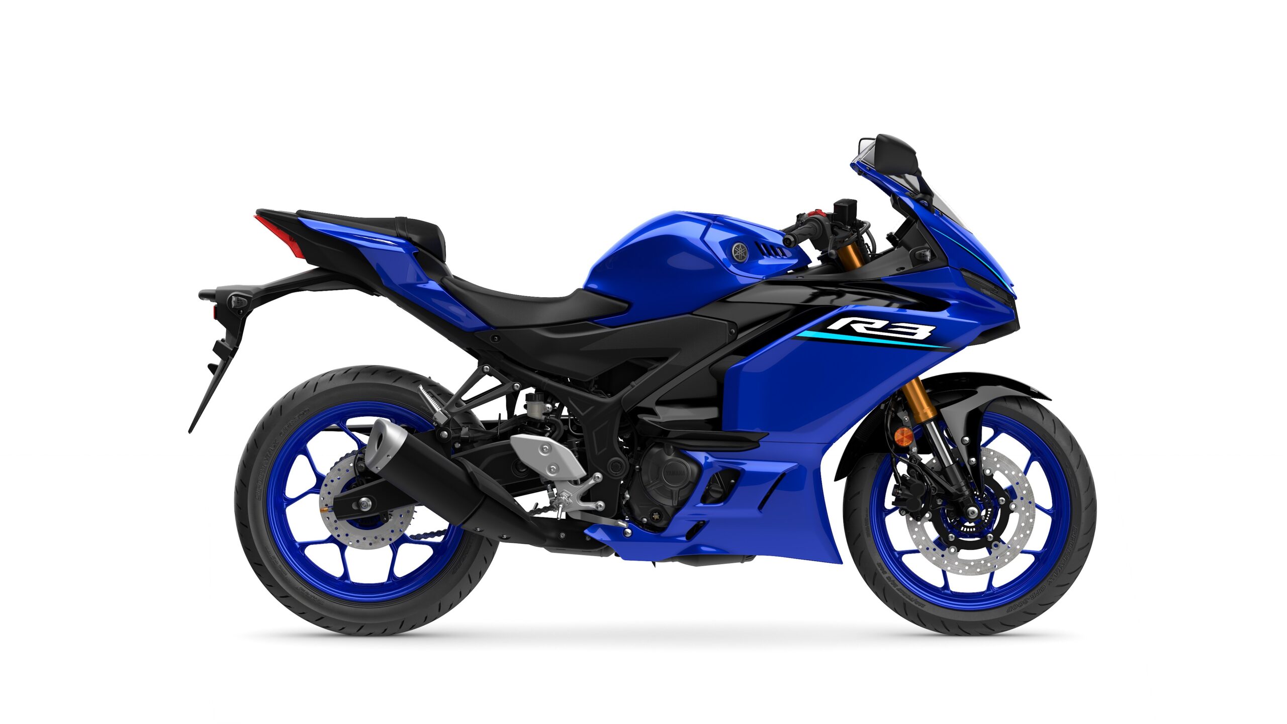 2026 Yamaha R3 Icon Blue Right A side view of a blue Yamaha R3 motorcycle, featuring a sporty design with a black and blue color scheme, sleek bodywork, and lightweight wheels.