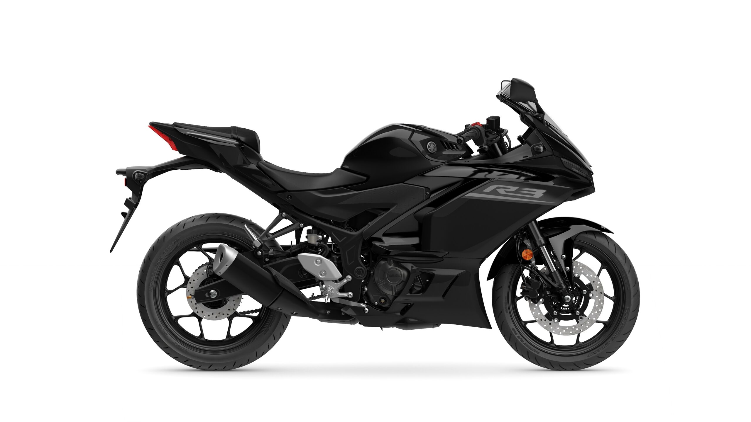 2026 Yamaha R3 Tech Black Right A sleek black motorcycle, the Yamaha YZF-R3, displayed in profile on a white background, showcasing its sporty design and modern features.