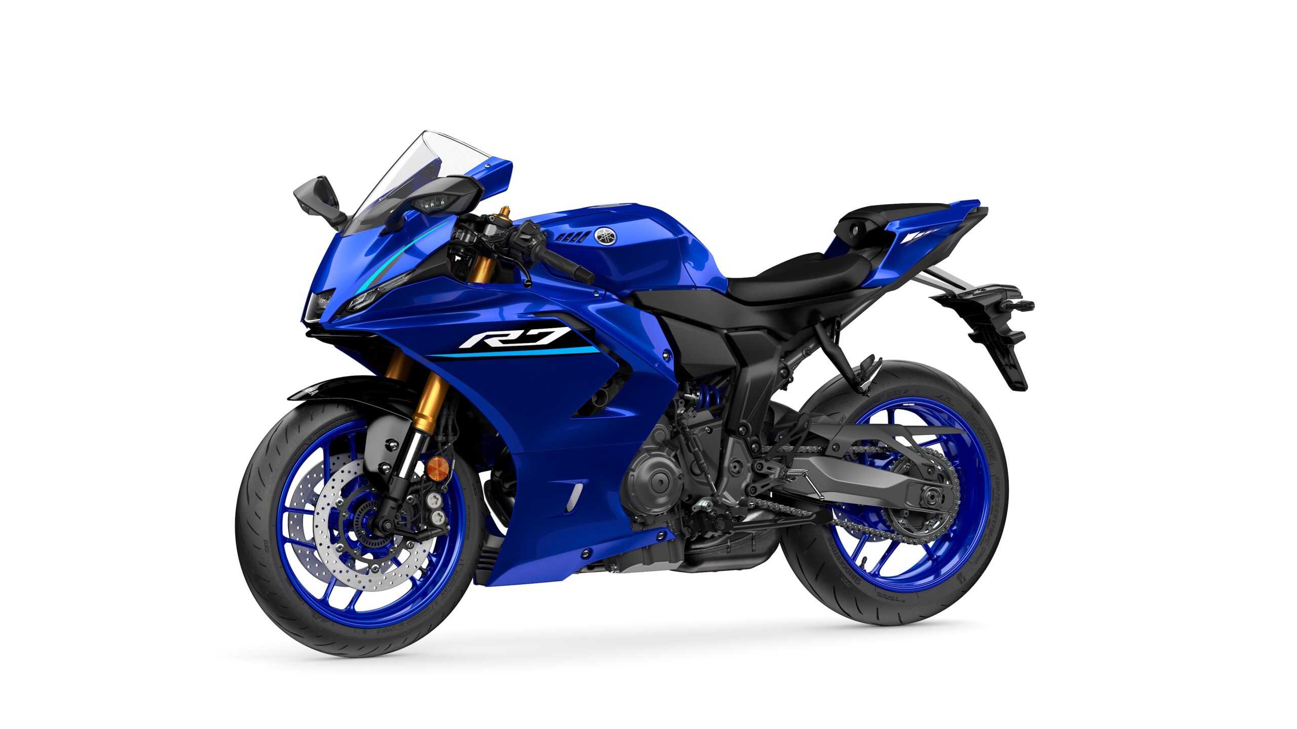 2026 Yamaha R7 Icon Blue Lateral Left A blue Yamaha R7 motorcycle displayed at a slight angle, showcasing its sleek design, sporty features, and distinctive styling.