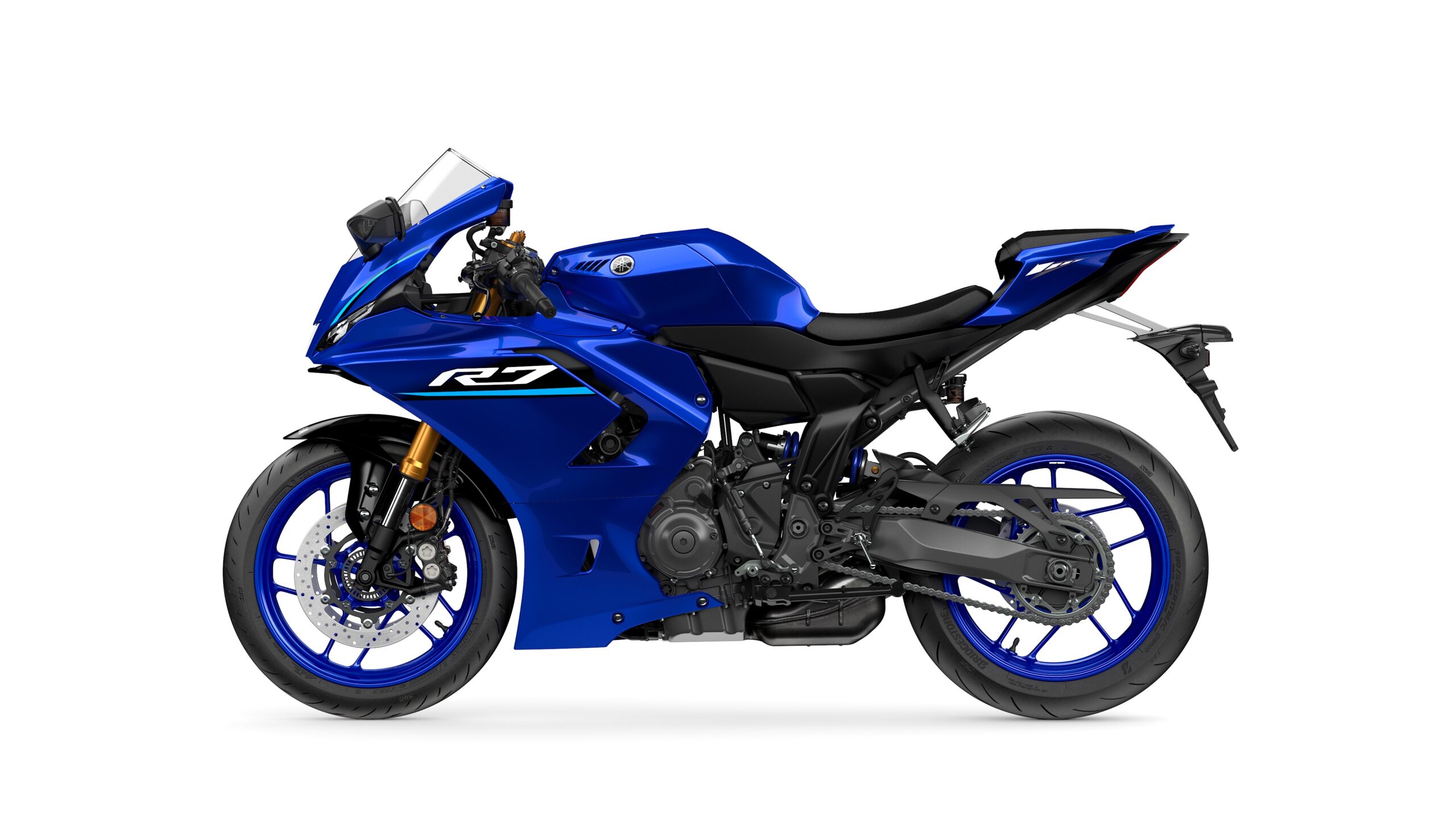 2026 Yamaha R7 Icon Blue Left A blue Yamaha R7 motorcycle shown in profile view, featuring sporty design elements such as a fairing, racing seat, and racing wheels.