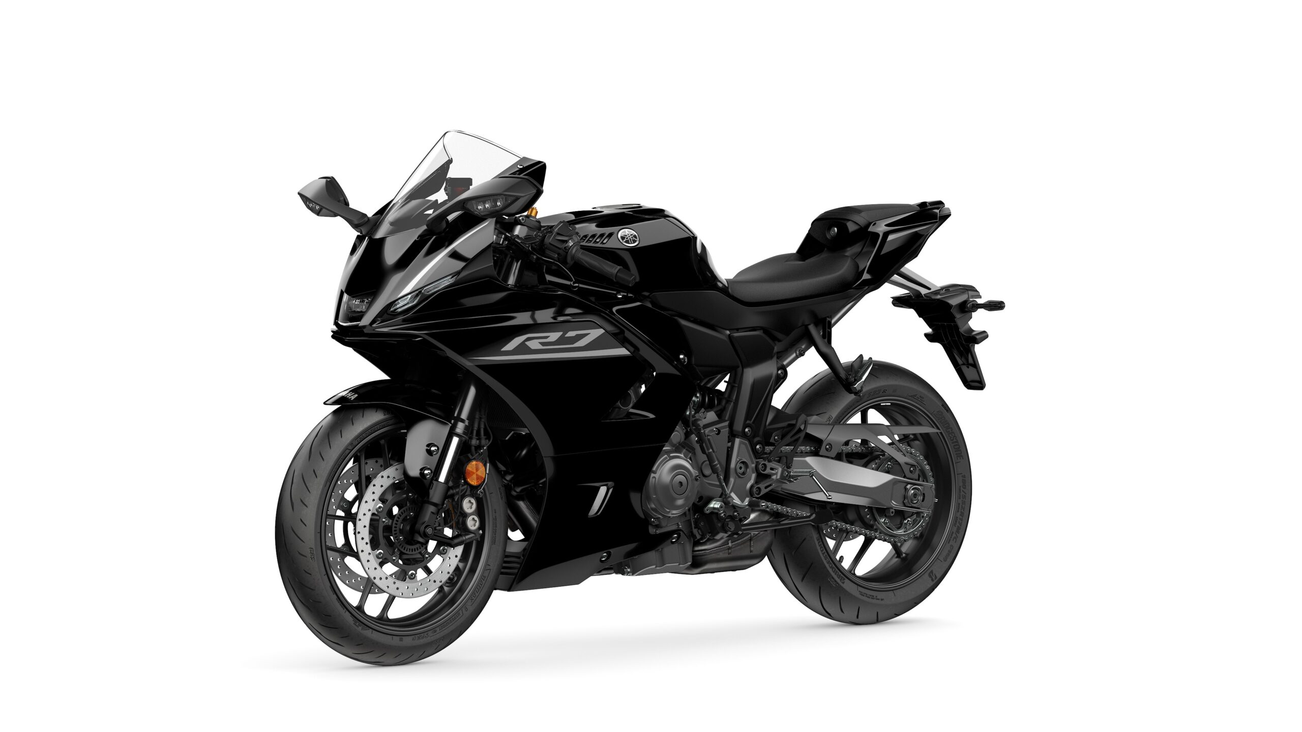 2026 Yamaha R7 Midnight Black Lateral Left A sleek black Yamaha R7 motorcycle positioned at a slight angle, showcasing its aerodynamic design and modern features.