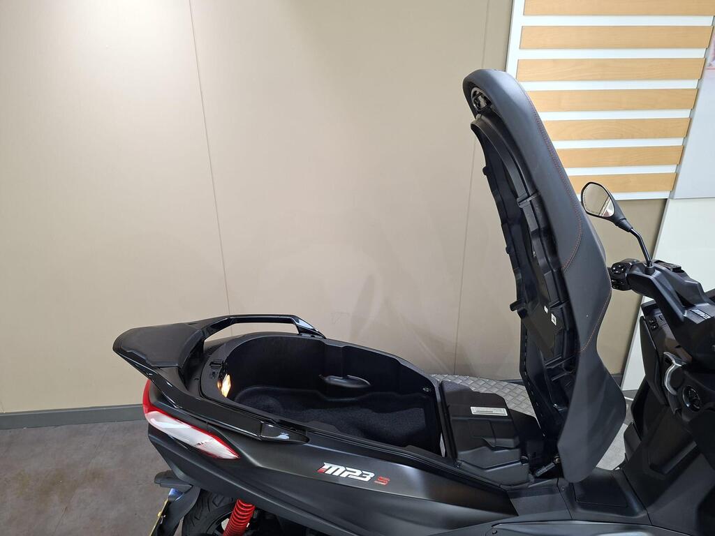 Piaggio MP3 400 LC72 KHB 8 A black scooter with an open trunk, showcasing its storage compartment, against a neutral background.