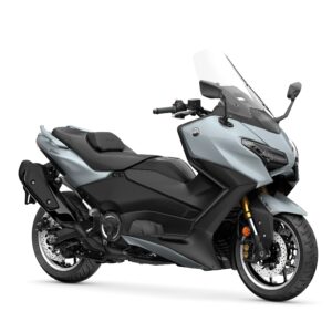 Yamaha 2026 TMAX Tech MAX A side view of a modern gray and black motorcycle with a tall windshield, showcasing sporty design features and a sleek profile.