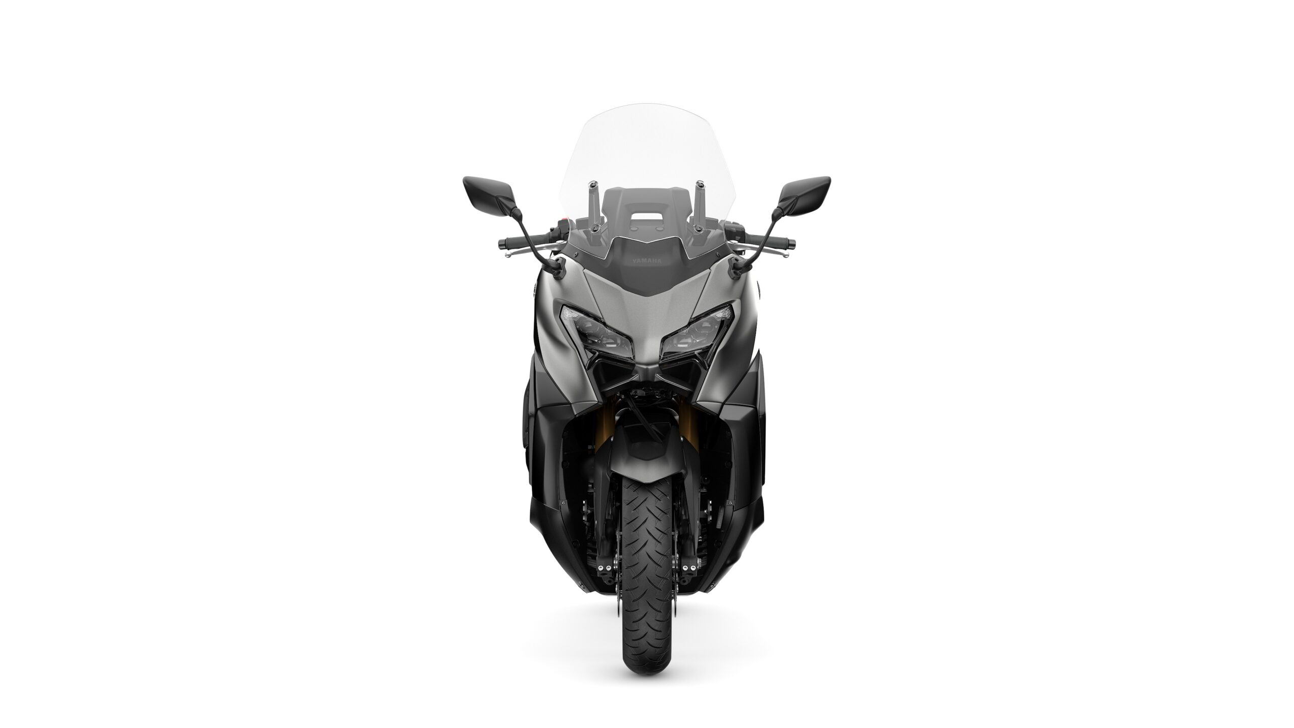 2026 Yamaha TMAX TECH MAX Crystal Graphite Front A front view of a sleek black motorcycle with a transparent windshield, showcasing its angular design and prominent wheel.