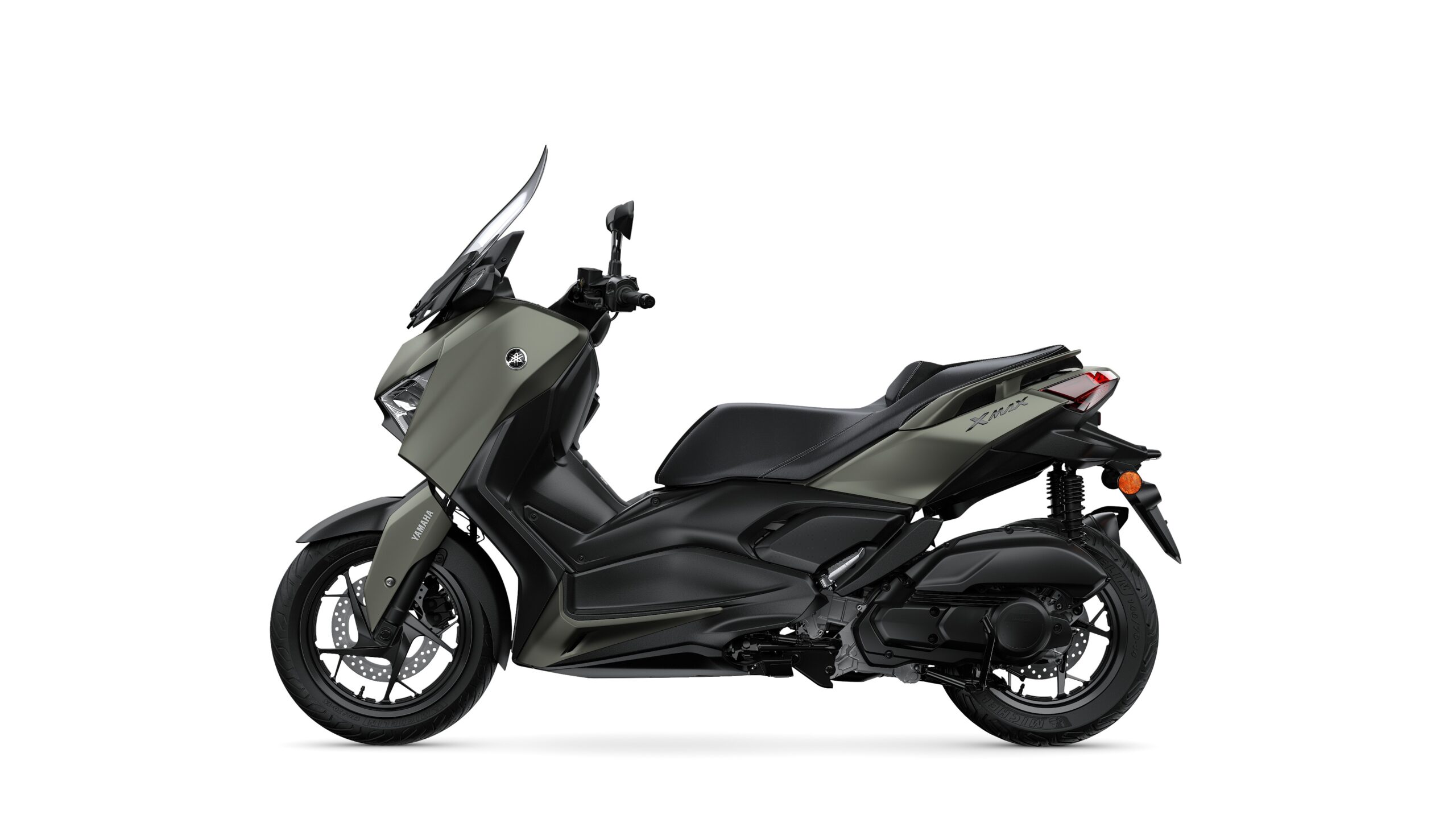 Yamaha 2026 XMAX 125 Tech Kamo Left A sleek, modern scooter in a matte olive green and black color scheme, featuring a streamlined body, a tall windshield, and sporty wheels, displayed against a white background.