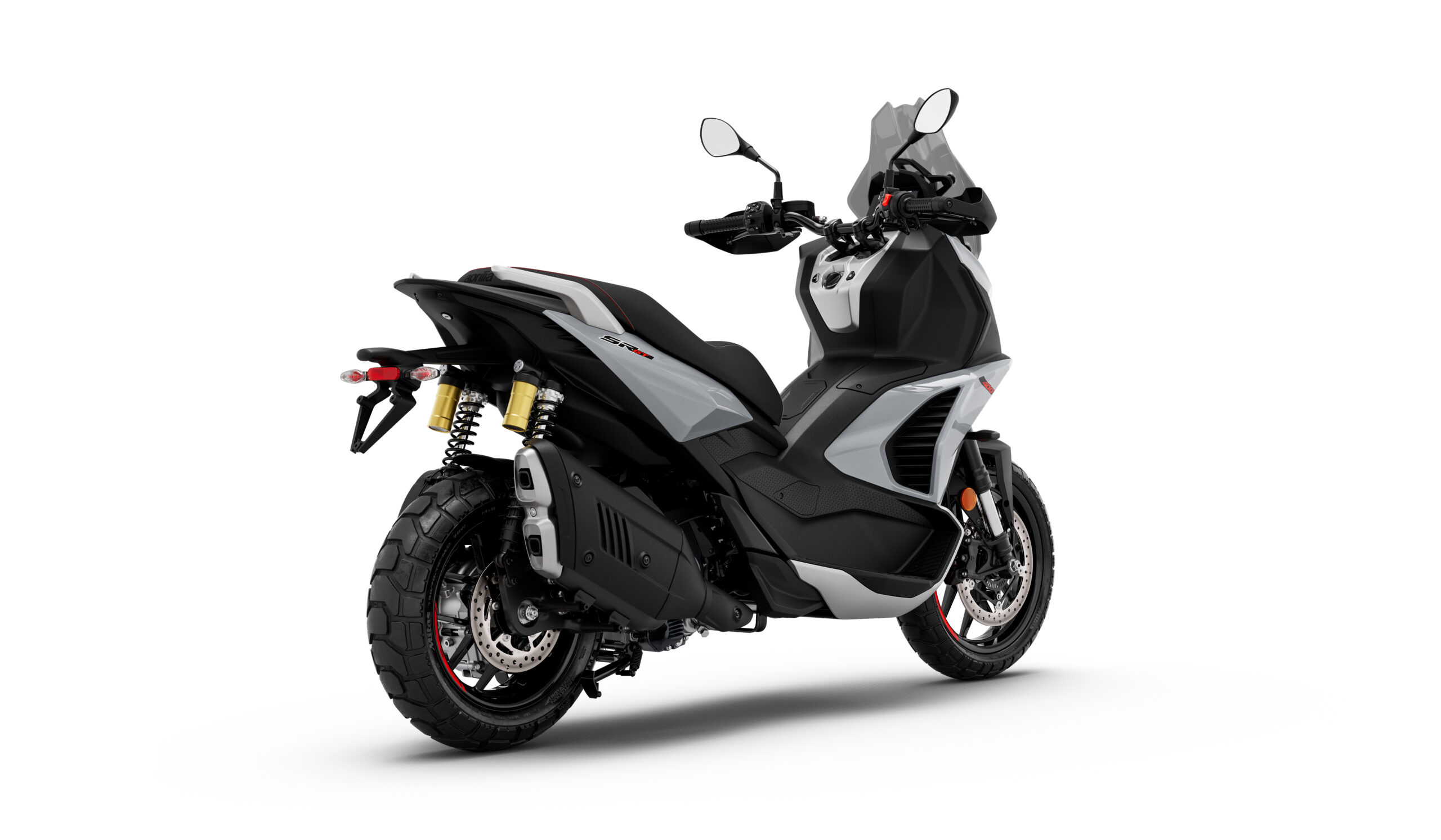 Aprilia_SR-GT-400_Dusty-Grey_3-4-post-dx A modern black and gray motorcycle is positioned at an angle, showcasing its rear and side features, including dual rear shocks, distinctive exhaust, and sporty tires.
