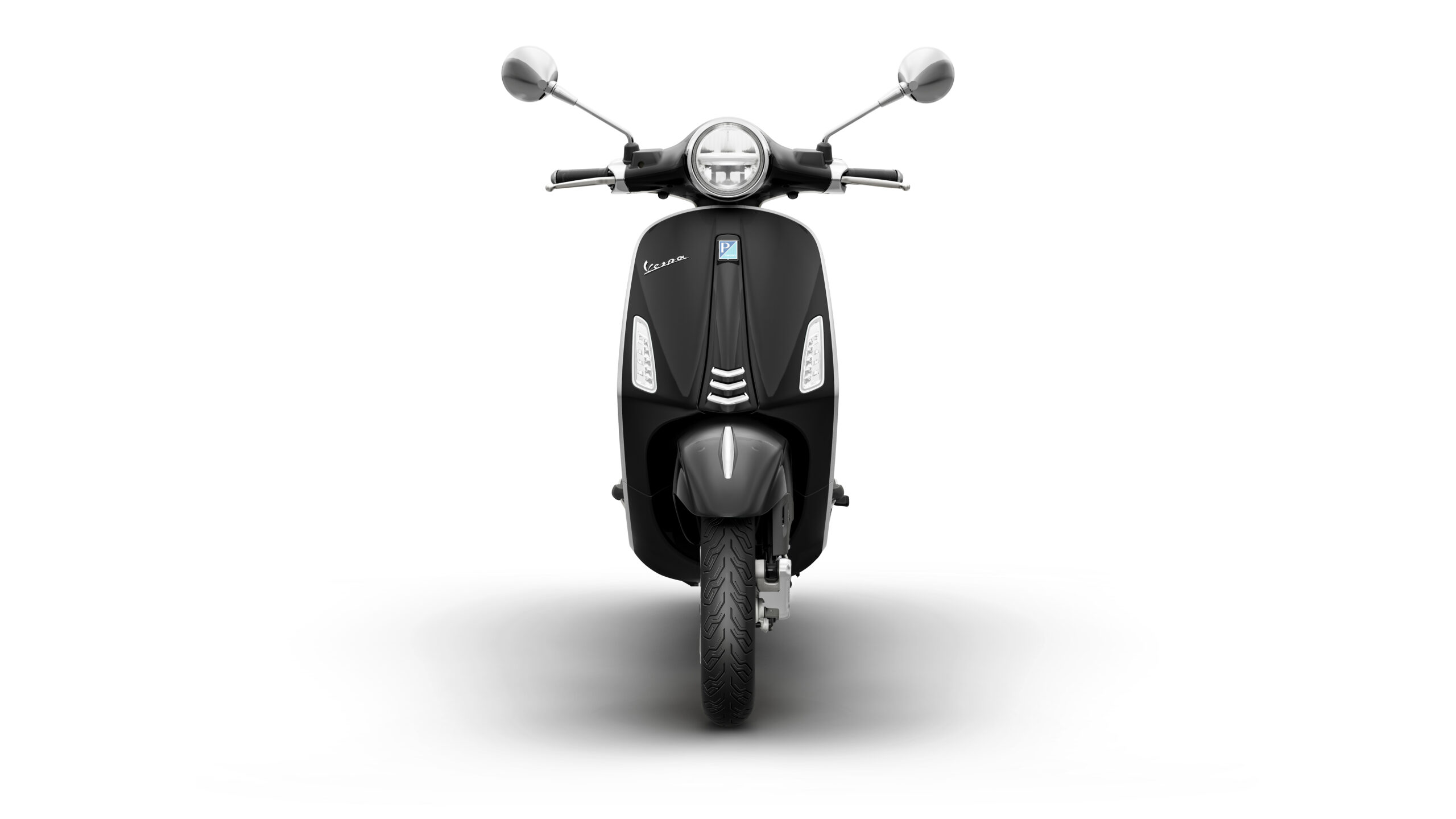 Primavera 125 2026 Nero Convinto Front Front view of a black Vespa scooter, showcasing its sleek design, round headlight, and chrome mirrors against a white background.