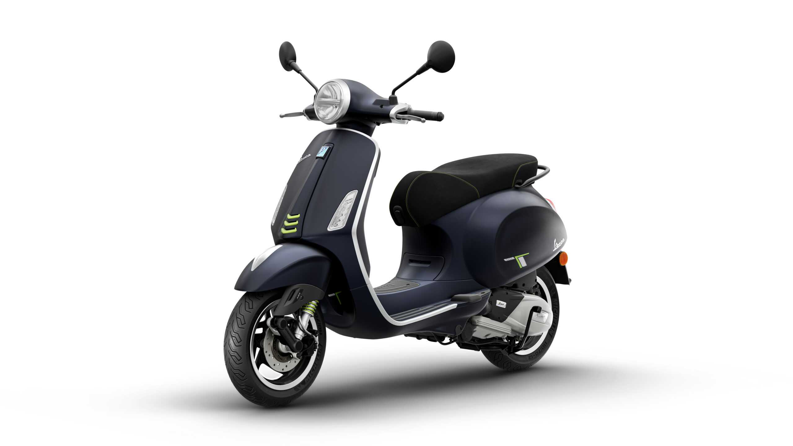 Primavera Tech 125 2026 Blu Energico Lateral Left A modern black scooter with a sleek design, featuring a round headlight, green accents, and a cushioned seat, positioned against a white background.