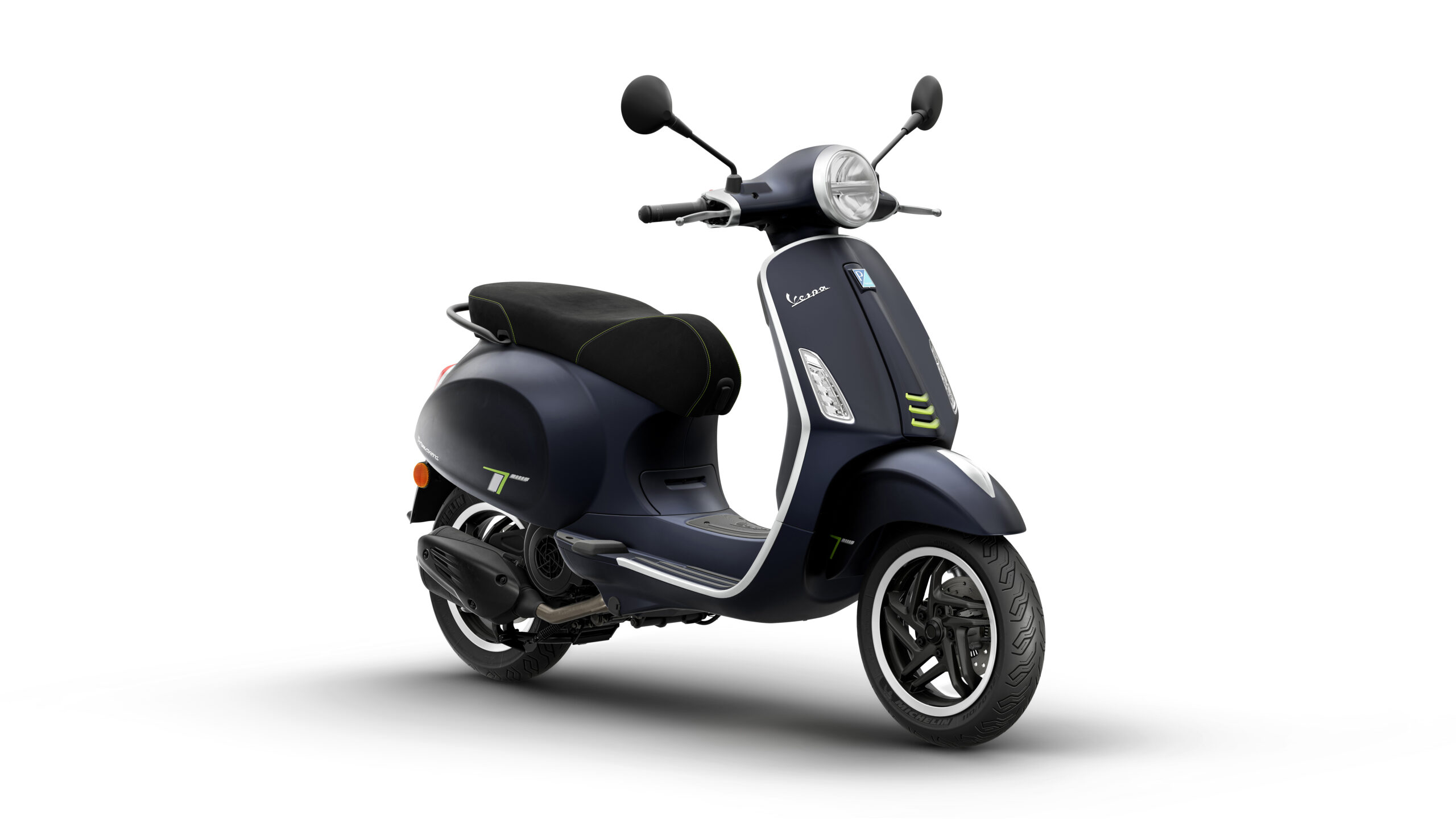 Primavera Tech 125 2026 Blu Energico Lateral Right A sleek navy blue scooter with a black seat, featuring modern design elements and green accents, positioned at an angle against a white background.