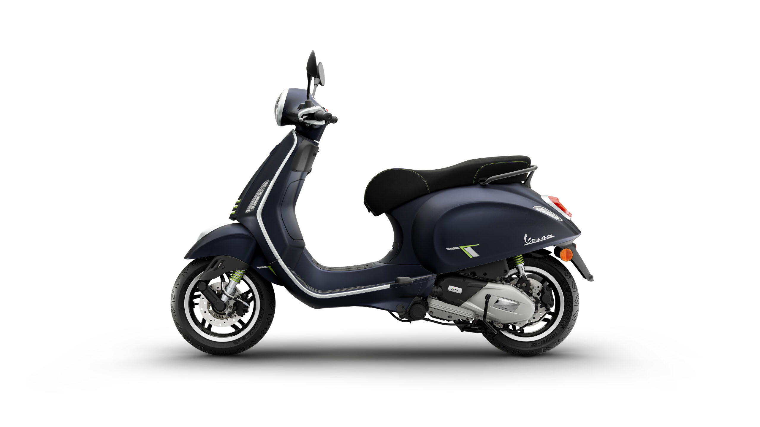 Primavera Tech 125 2026 Blu Energico Left A sleek, dark blue scooter with a curved design, featuring a black seat and vibrant green accents, viewed from the side against a white background.
