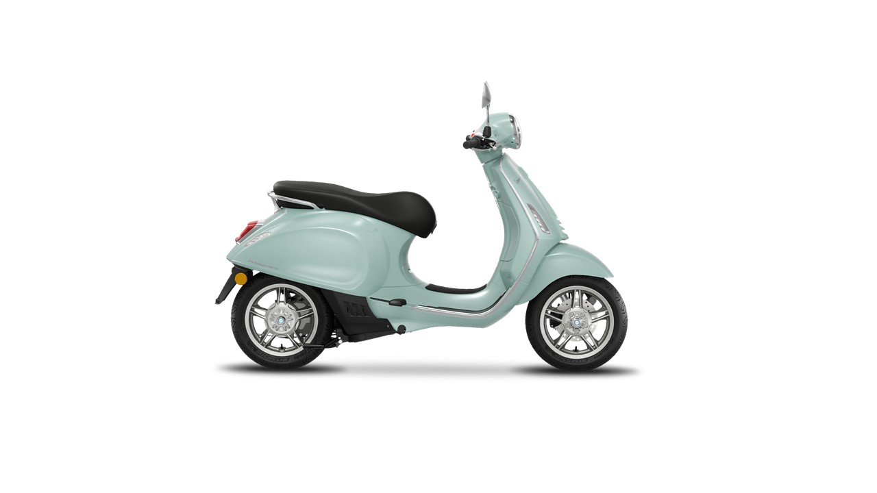 Primavera Elettrica Verde Amabile A mint green scooter with a black seat, viewed from the side, showcasing its sleek design and chrome wheels.