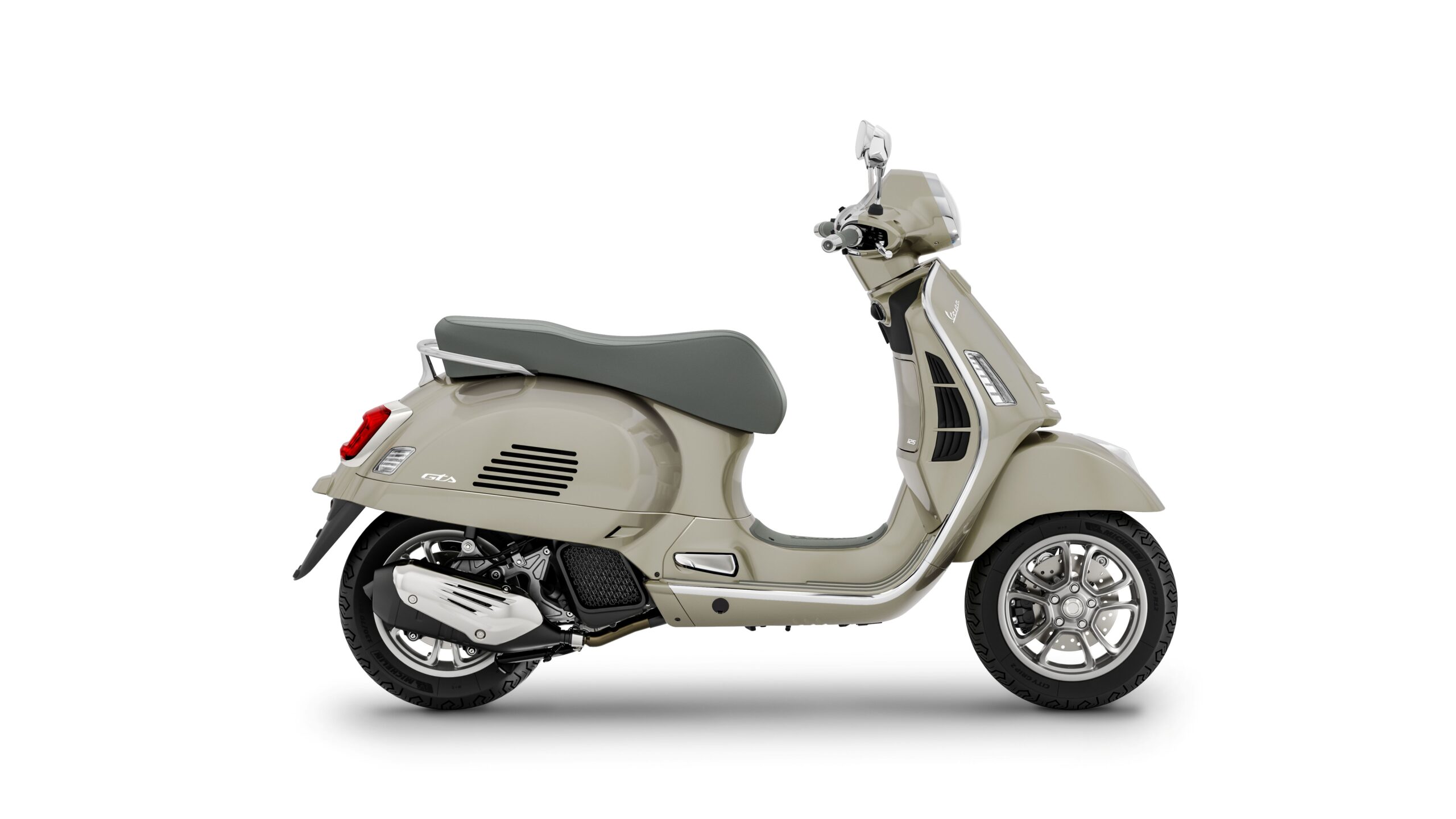 Vespa GTS 125 2026 Beige Avvolgente Right A beige scooter with a grey seat, positioned at a slight angle, featuring chrome accents and five-spoke wheels.