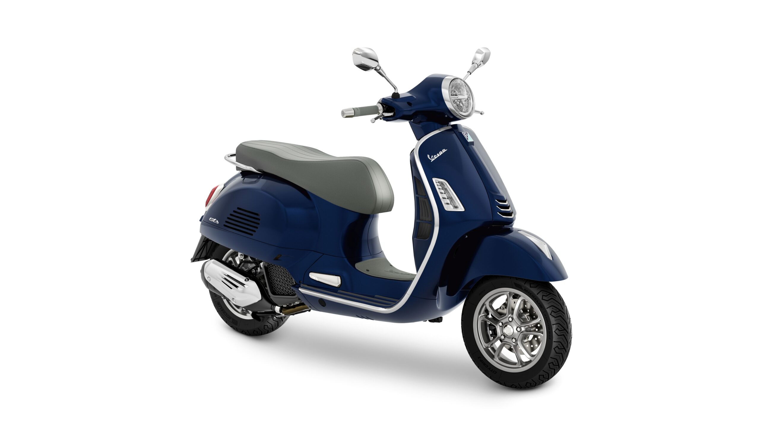 Vespa GTS 125 2026 Blu Energico Lateral Right A blue Vespa scooter with a gray seat, side mirrors, and a vintage design, positioned at a slight angle against a white background.