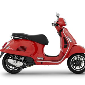 A side view of a red Vespa scooter with a sleek design, featuring a black seat and chrome accents.