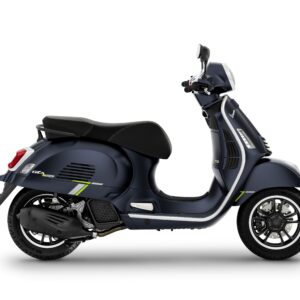 A dark blue Vespa scooter with a sleek design, featuring green accents, seen from the side.