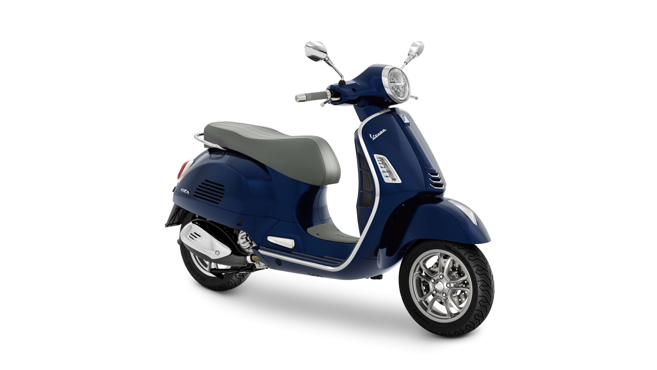 Vespa GTS 310 2026 Blu Energico Lateral Right A navy blue Vespa scooter with a gray seat, showcasing a classic design and chrome accents, positioned at an angle on a white background.
