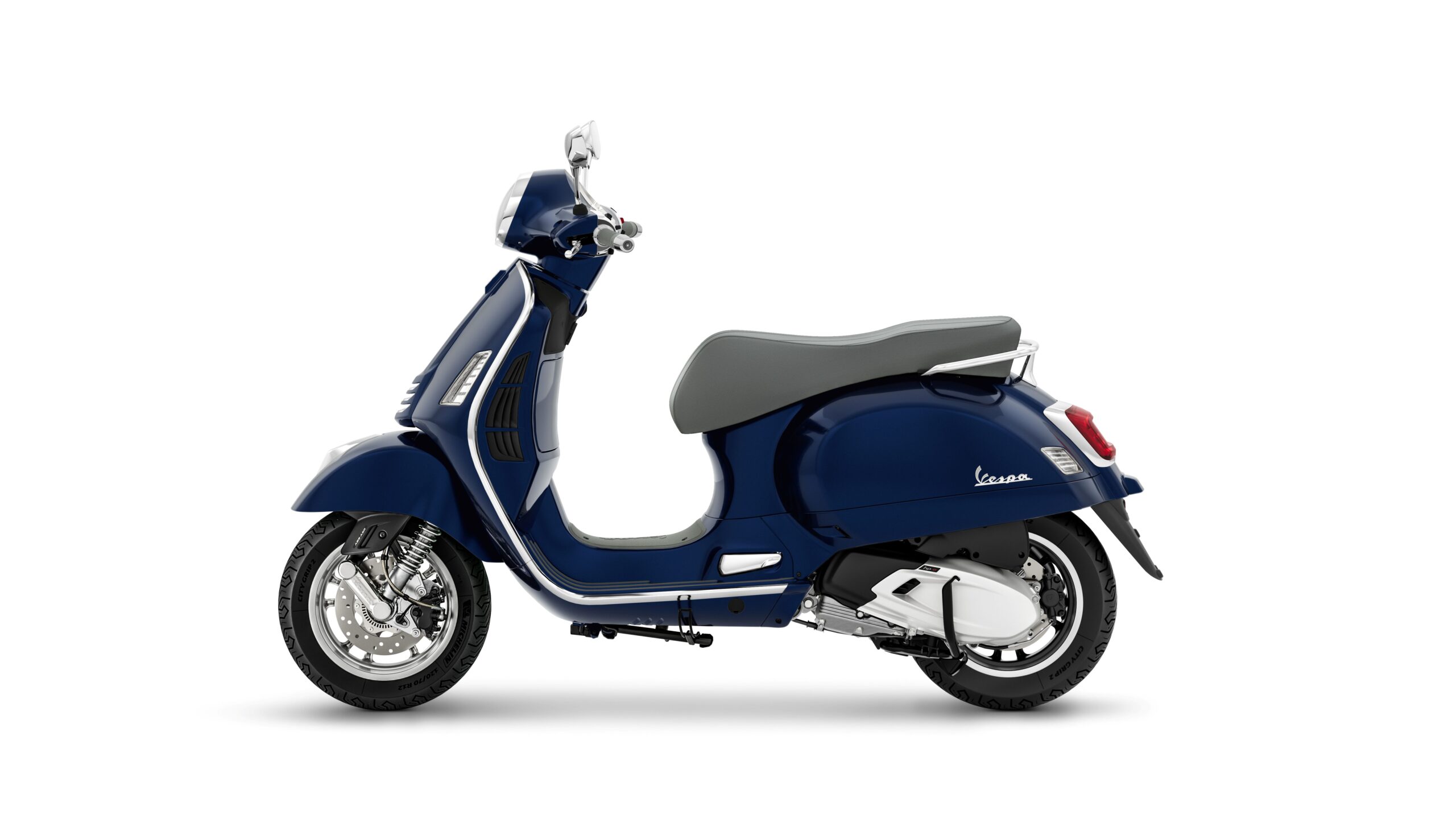 Vespa GTS 310 2026 Blu Energico Left A navy blue Vespa scooter with a gray seat, shown from the side against a white background.