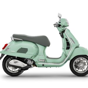 A mint green Vespa scooter viewed from the side, featuring a sleek design, cushioned seat, and chrome details.