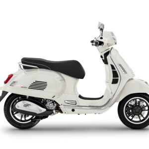 A white Vespa scooter with a black seat, shown from the side, featuring a sleek design and modern components.