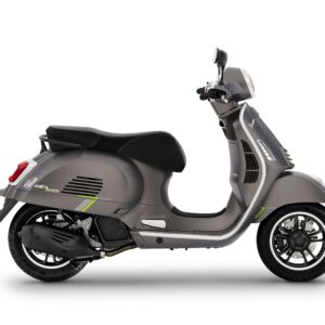 A side view of a gray Vespa scooter featuring sleek design elements, green accents, and modern styling.