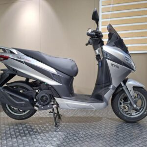 Aprilia SXR 50 2026 A silver Aprilia scooter displayed on a textured surface against a neutral background.
