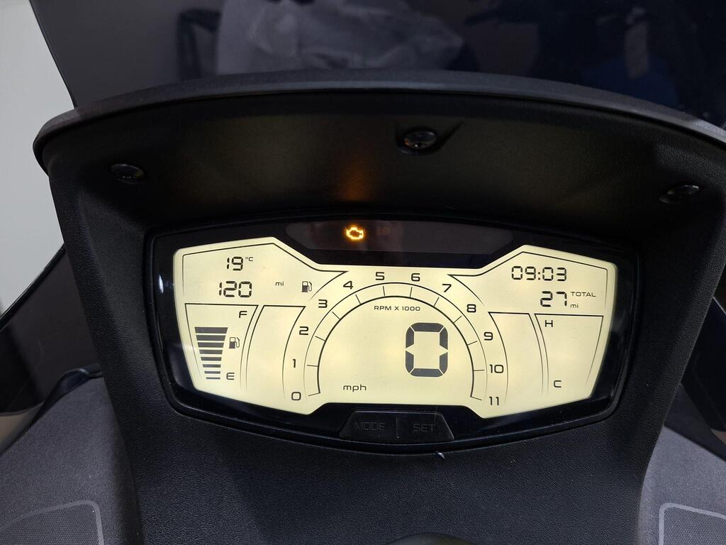 Aprilia SXR 50 2026 22 Digital motorcycle dashboard displaying speed (0 mph), distance (120 miles and total 27 miles), engine RPM, fuel level (F to E), temperature (19°C), and time (09:03).
