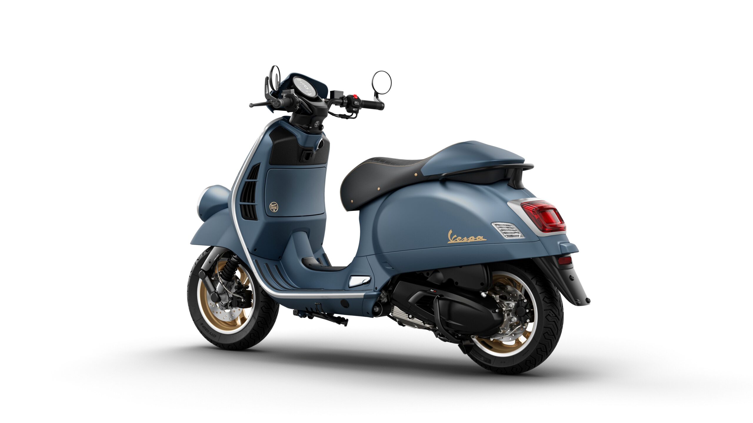 Vespa GTV 125 MY26 Officina Lateral Left Rear A blue Vespa scooter with a sleek design and gold accents, viewed from the rear-right angle, showcasing its modern aesthetic and stylish curves.