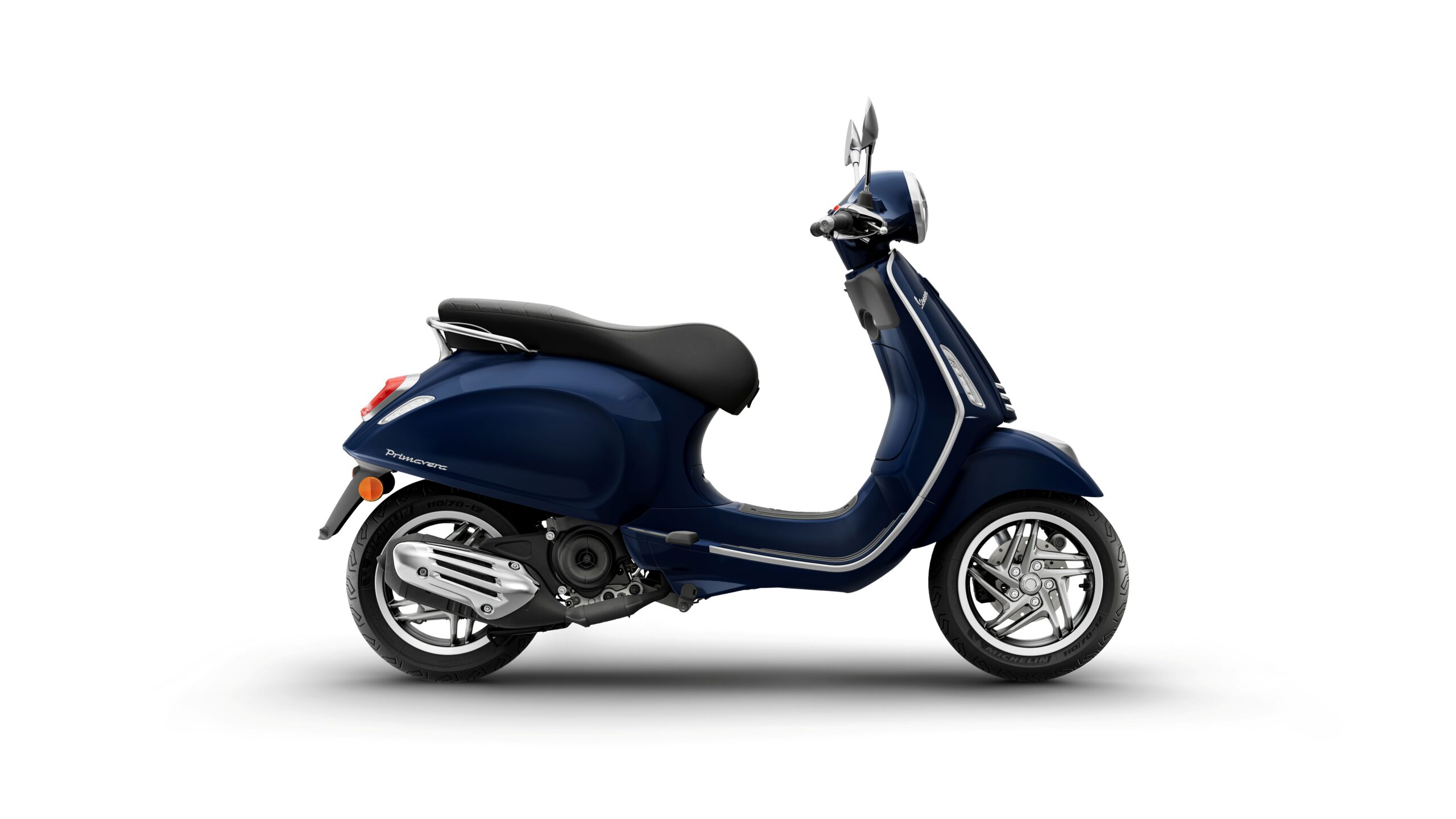 Vespa Primavera 50 MY26 Blue Energico Right A blue scooter with a sleek design is positioned against a white background, showcasing its chrome details and smooth curves.